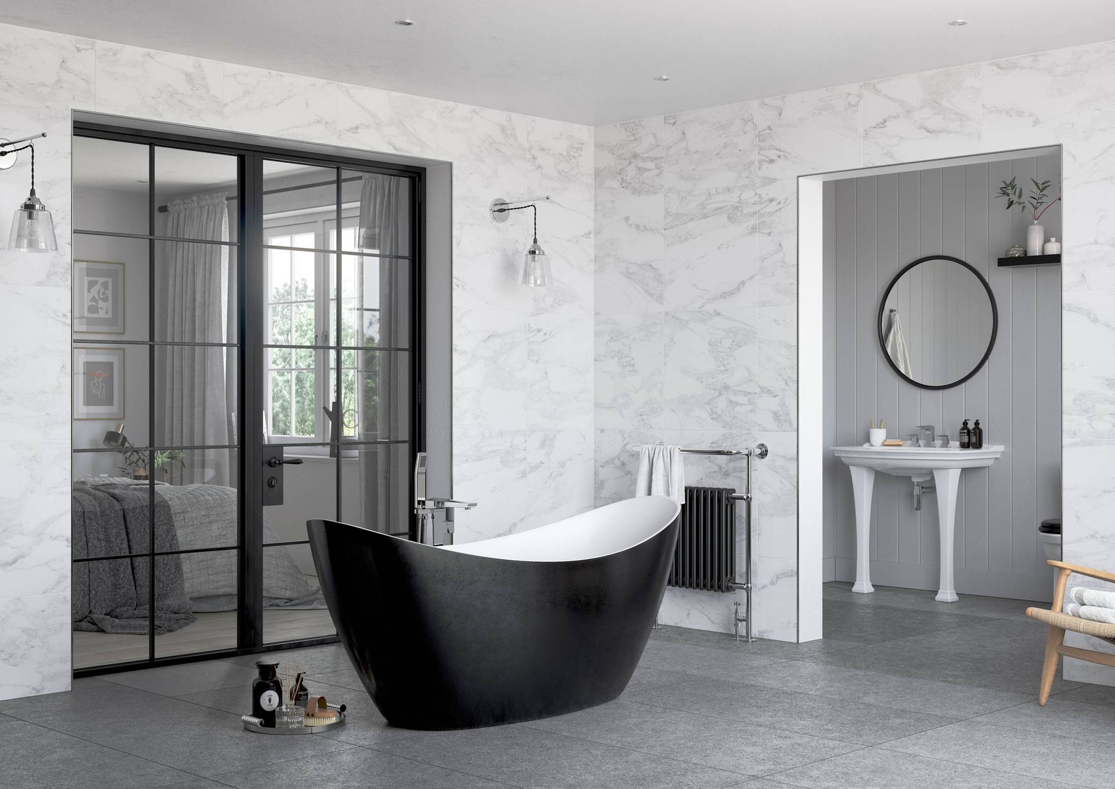 A black freestanding slipper bath against marble-effect tiling, a column radiator and towel rail beyond, and black-framed glazed doors through to a bedroom.